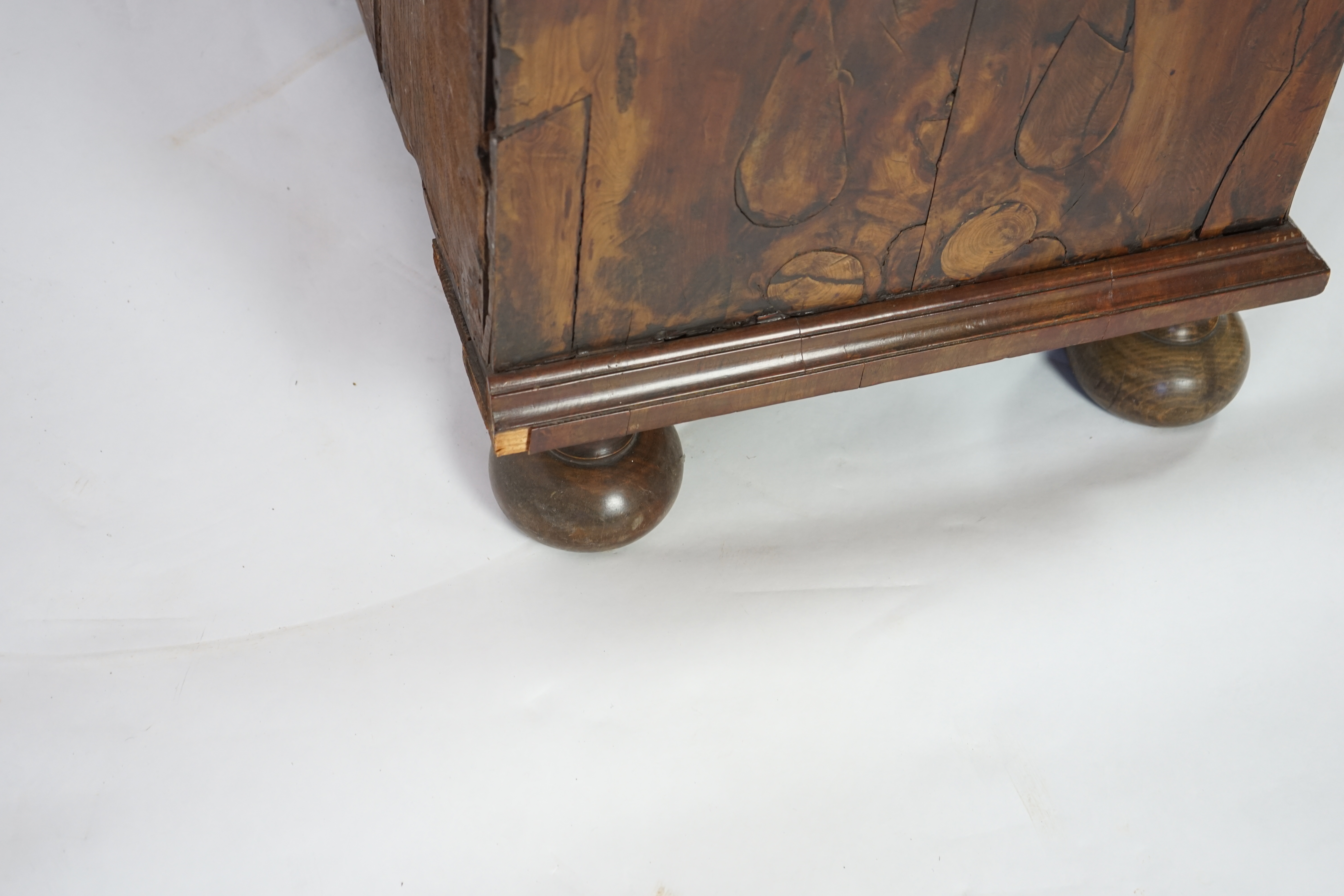 An early 18th century and later yew wood veneered oak chest